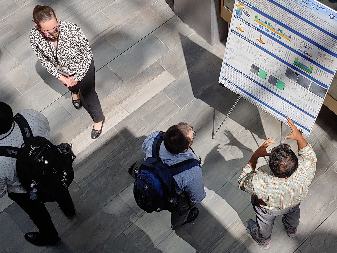 view from above of students at the IIRM-URA Technical Review's poster session.
