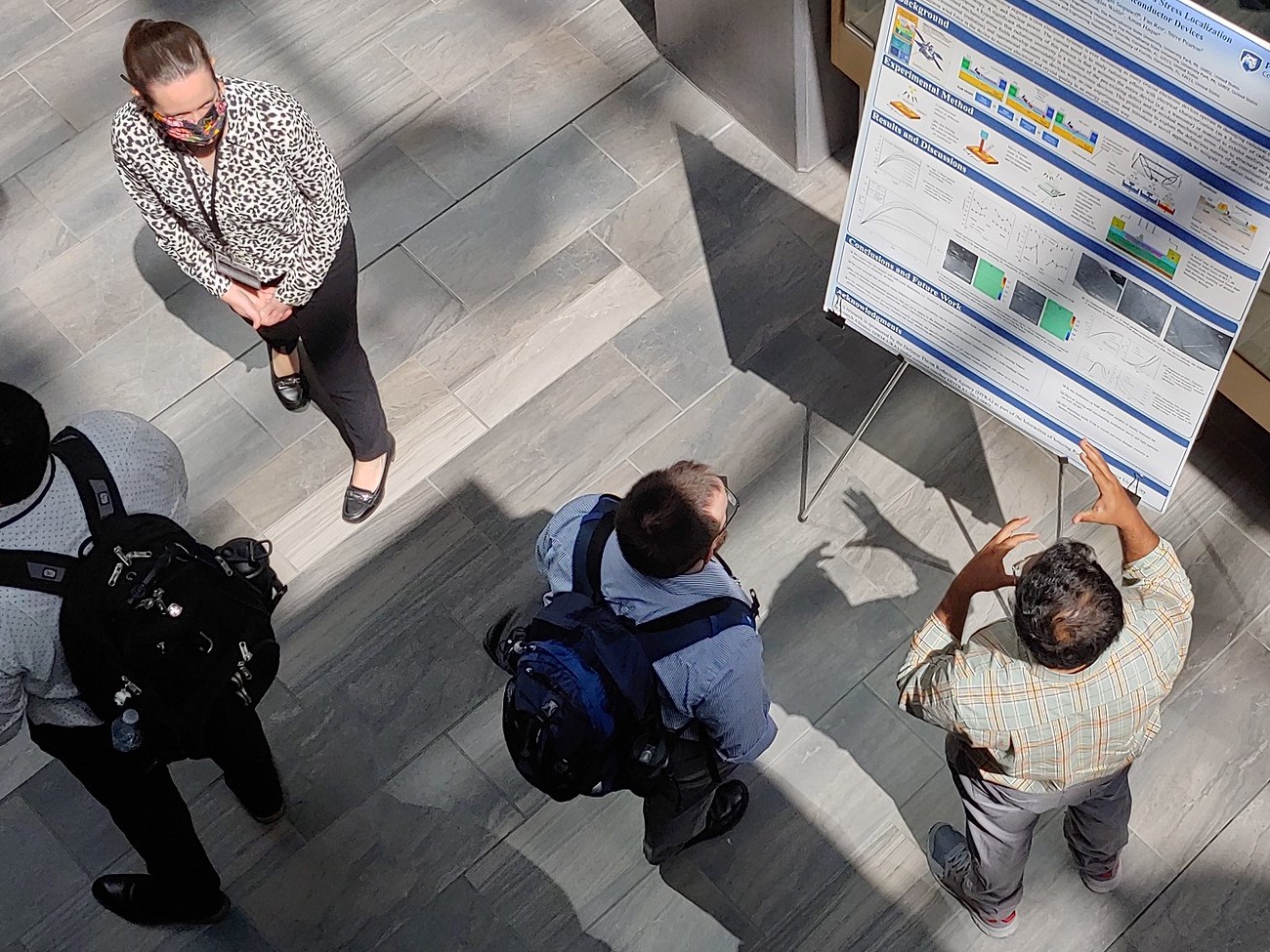 view from above of students at the IIRM-URA Technical Review's poster session. 