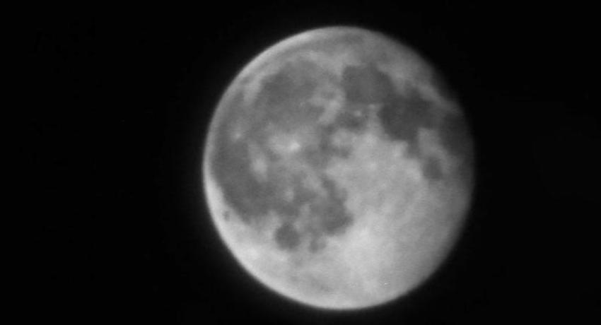 A black and white, close up photograph of the moon